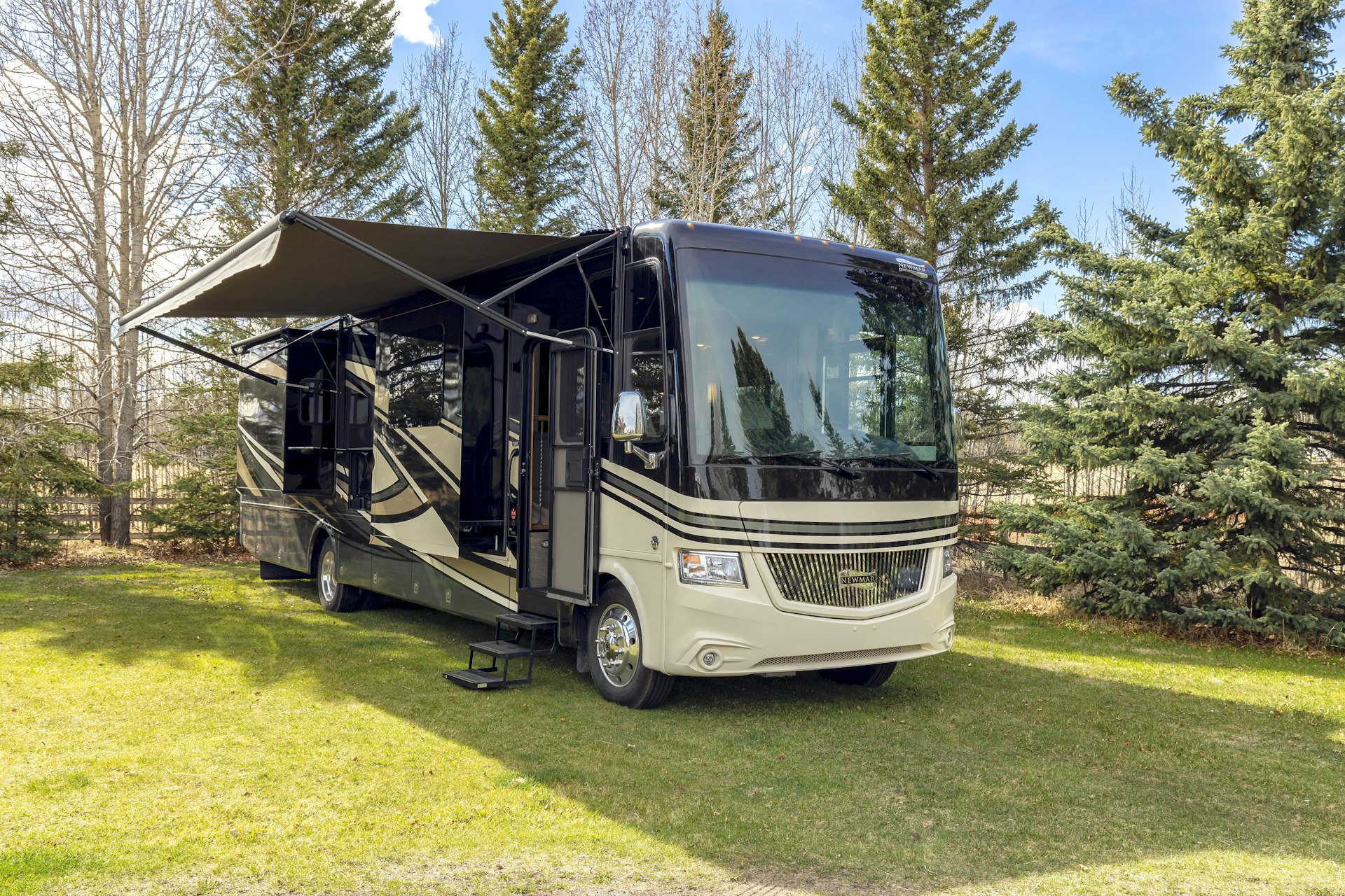 Clean Class A motorhome parked at a wooded campsite in the Quad Cities area
